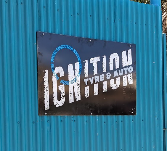 The Ignition Tyre and Auto sign mounted on the fence at the workshop